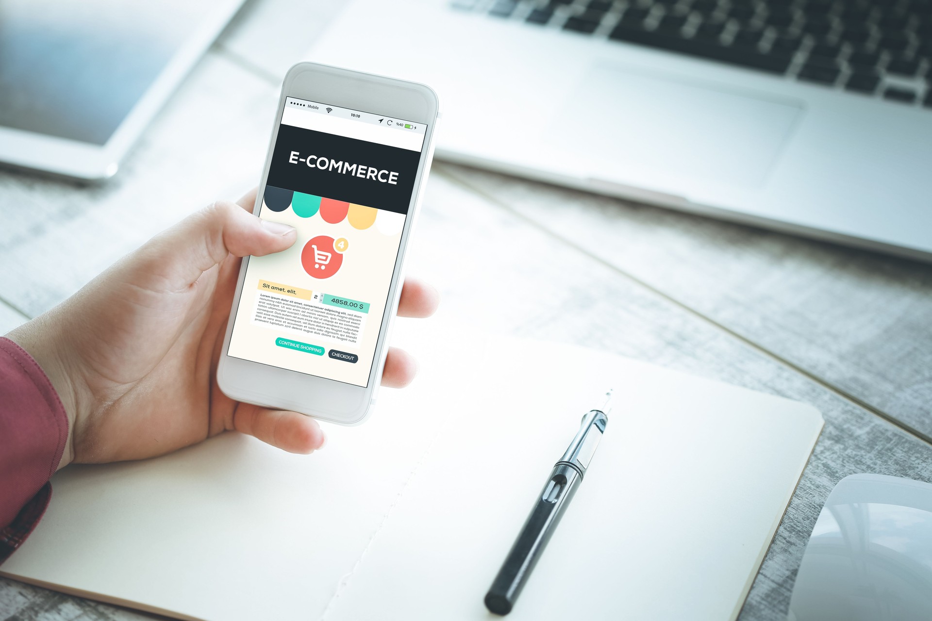 Smartphone in hand and showing E-Commerce concept on screen